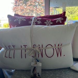 Rae Dunn Let it snow with 2 snowflake red pillows.